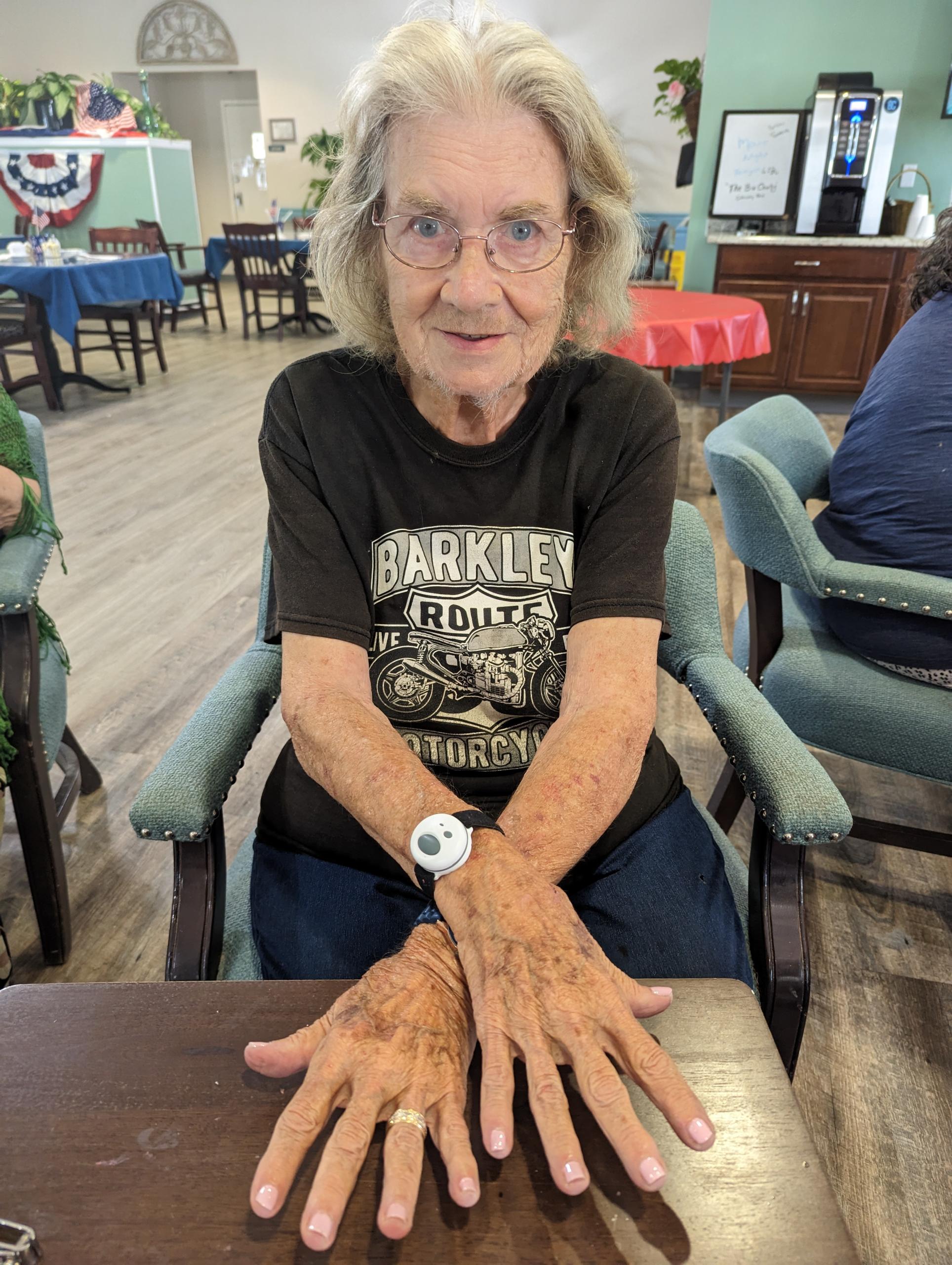 assisted living resident manicure showing her hands off