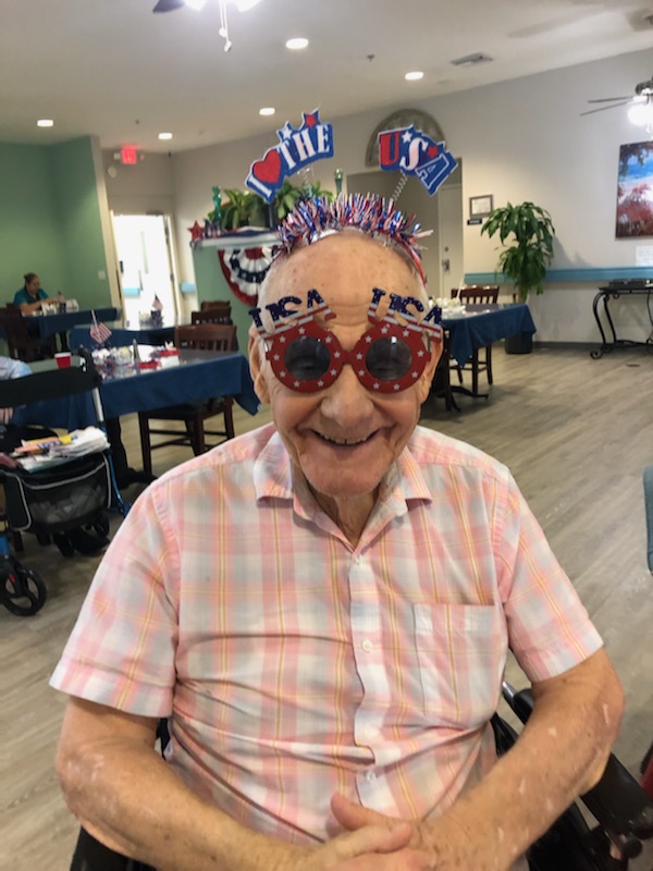 assisted living resident Pat smiling wearing funky glasses