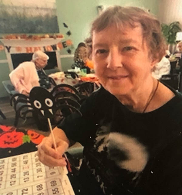 assisted living resident painting Halloween decor