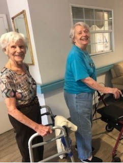 assisted living residents walking the hall to exercise
