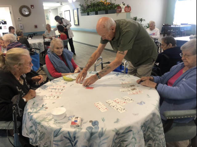 assisted living residents playing cards
