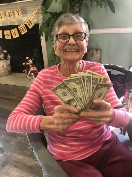 assissted living resident showing off her winnings