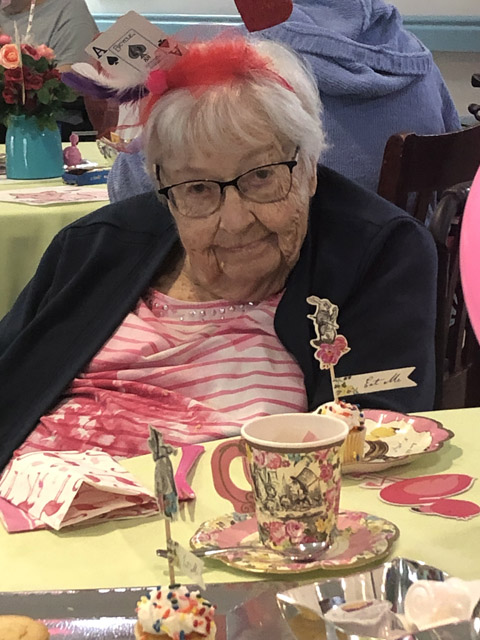 assisted living resident enjoying the tea party