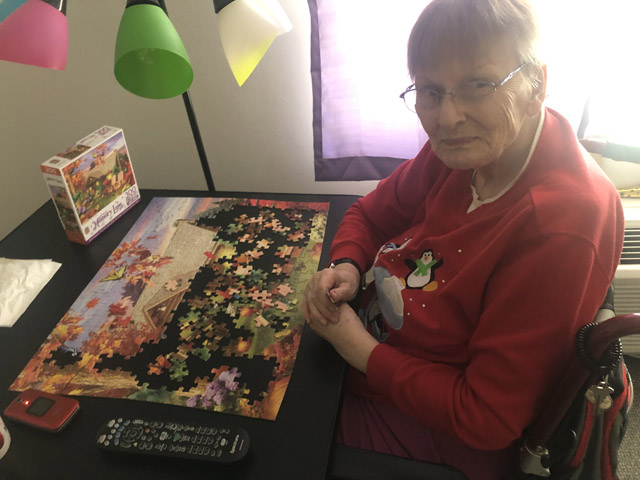 assisted living resident with her puzzle