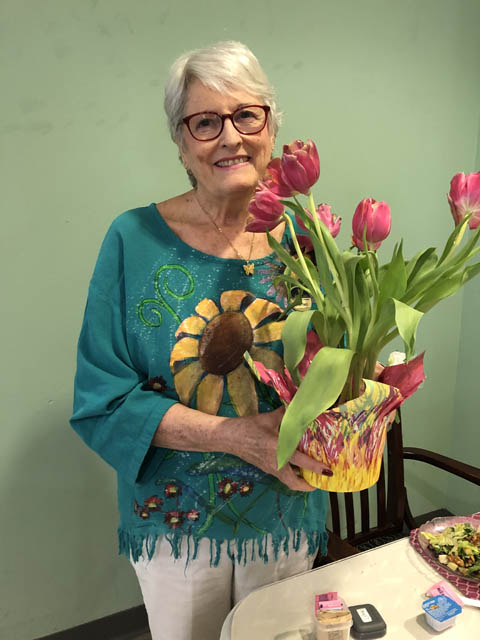 happy Cabot Cove resident with flowers