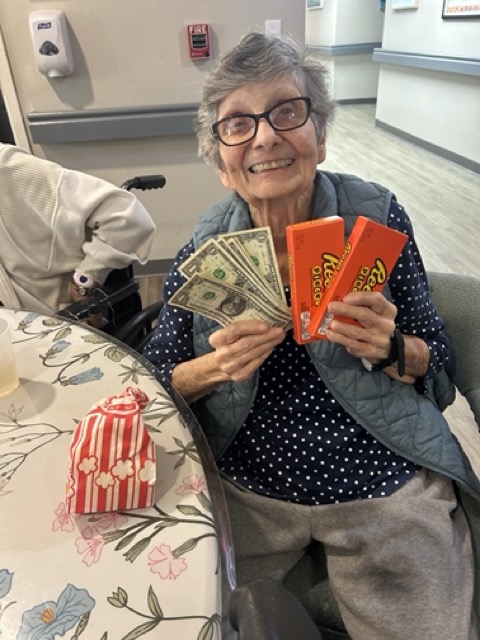 senior resident showing off her winnings